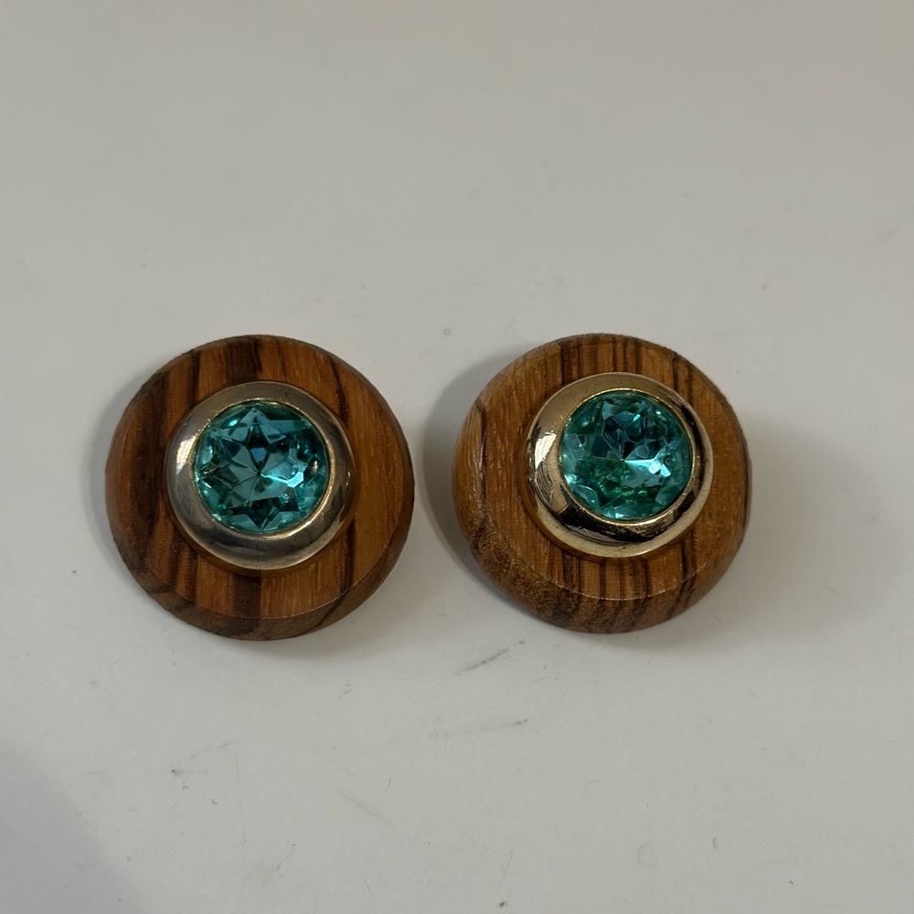 Vintage Diva Stud Earrings blue gemstone set in gold tone bezel on wooden Base